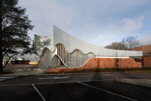Modern building with curved white metal facade
