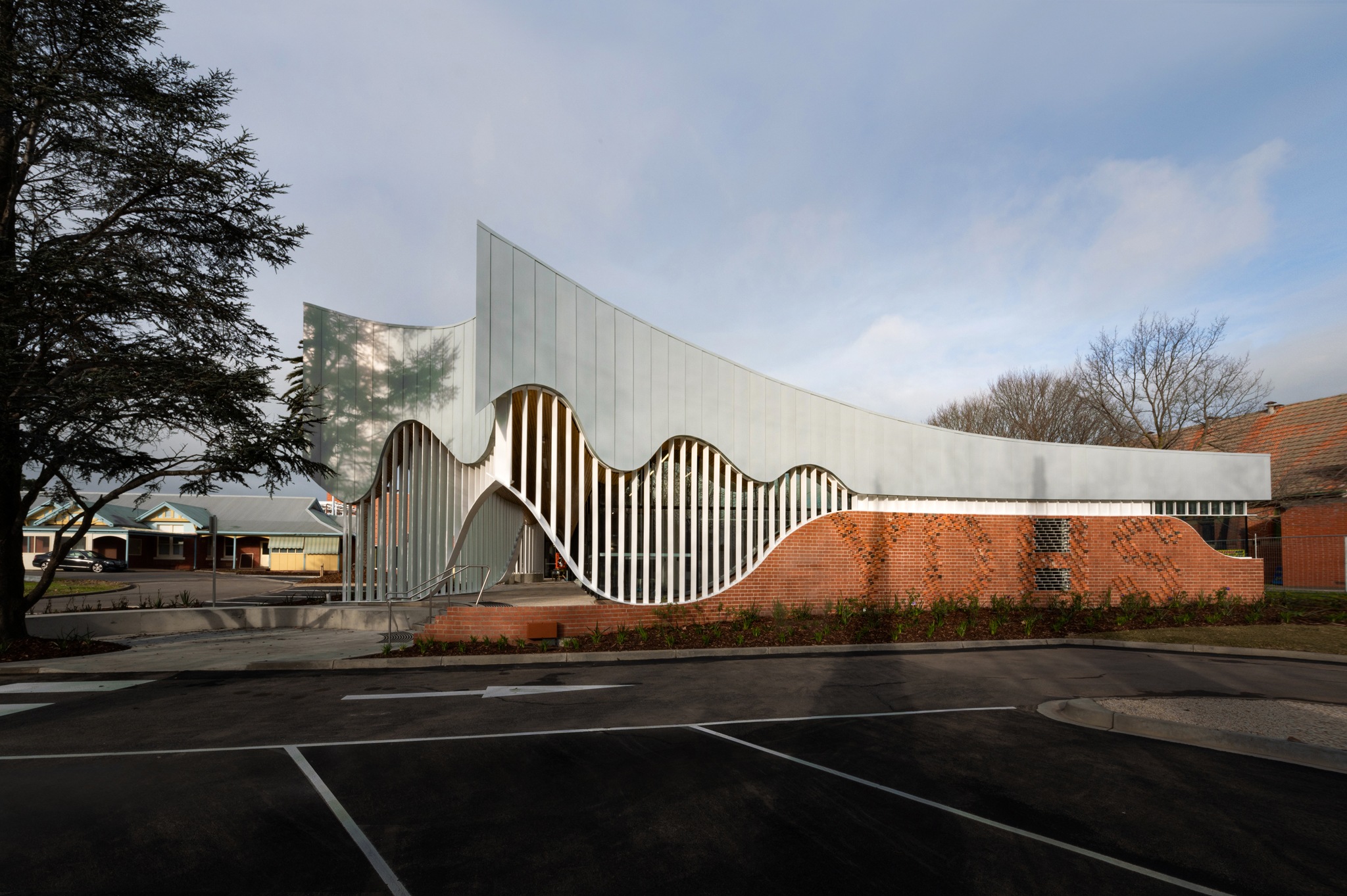 Modern building with curved white metal facade