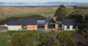 Modern rural home overlooking rolling hills and water