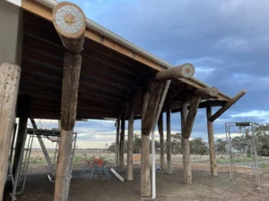 Timber posts supporting rural building under construction