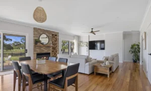 Modern open-plan living room with brick fireplace