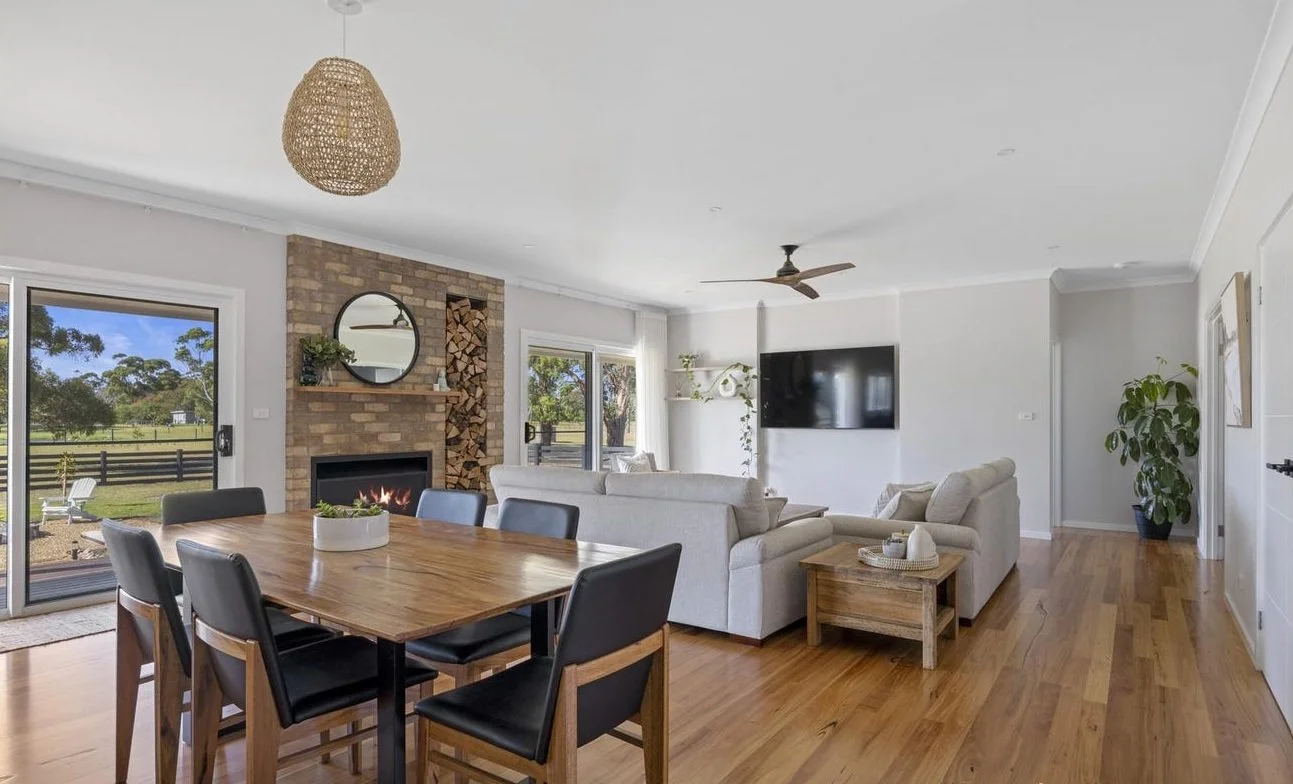 Modern open-plan living room with brick fireplace