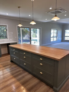Modern kitchen with timber island and pendant lights