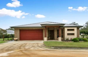 Modern single-storey brick home with red garage