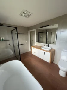 Modern bathroom with freestanding bath and timber vanity