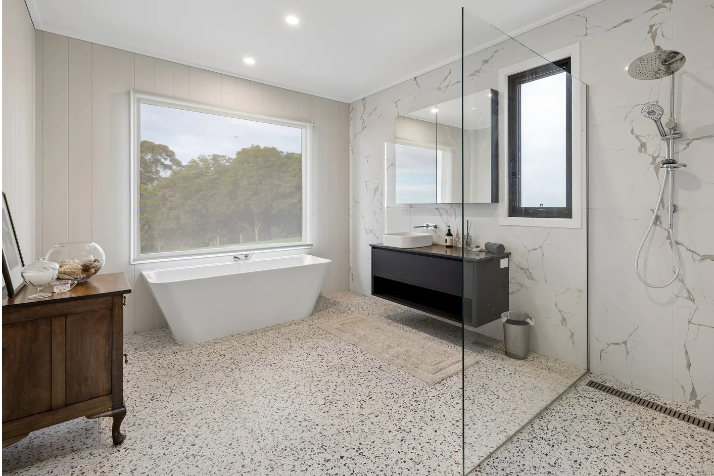 Modern bathroom with freestanding tub and glass shower