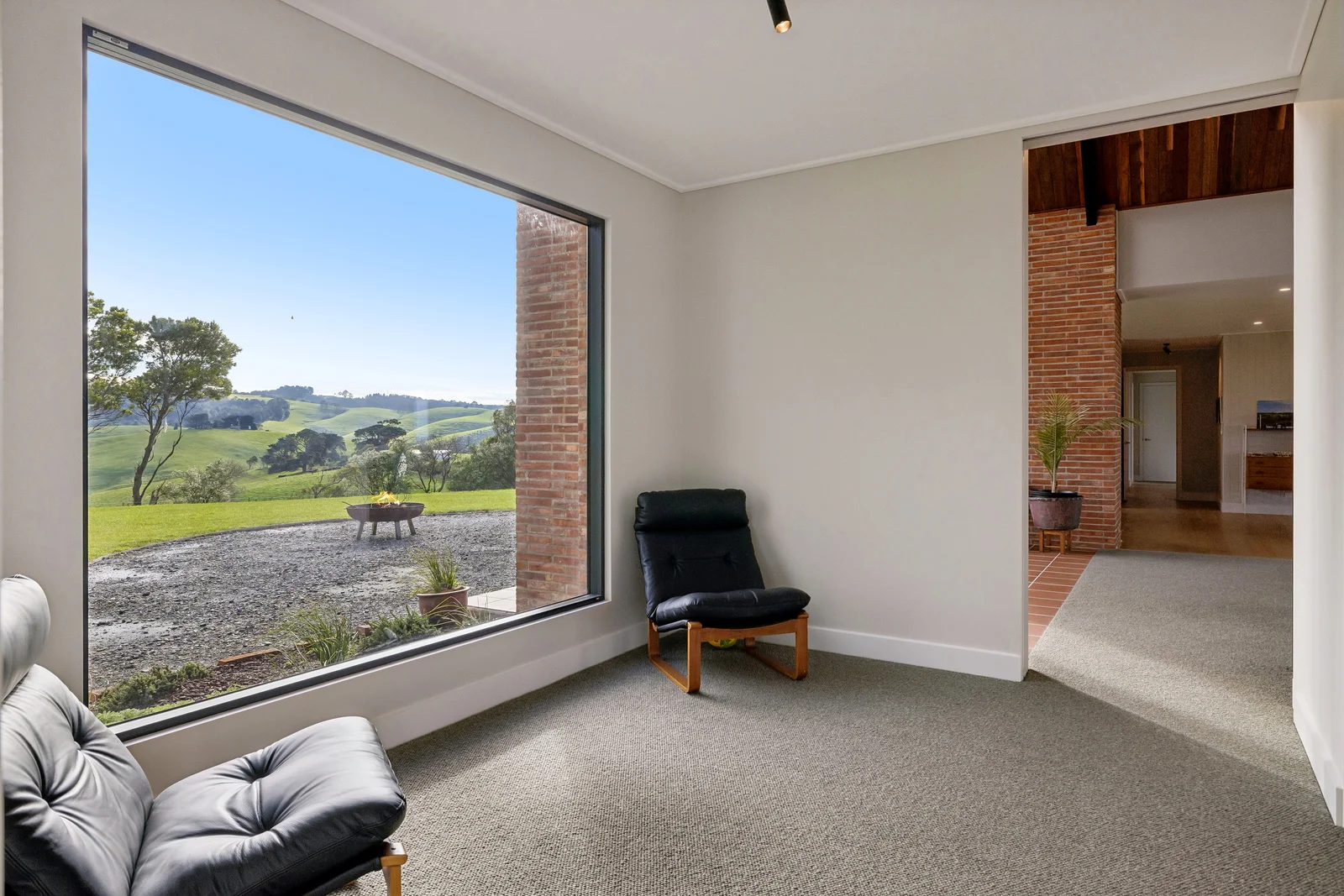 Modern room overlooking rolling green countryside hills